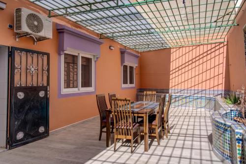 a patio with a table and chairs and a building at jaws wave agadir 1 in Agadir