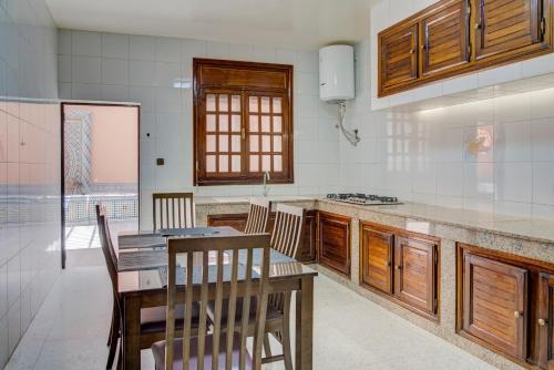 a kitchen with a table and some chairs and a counter at jaws wave agadir 1 in Agadir