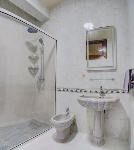 a bathroom with a sink and a shower and a toilet at jaws wave agadir 1 in Agadir