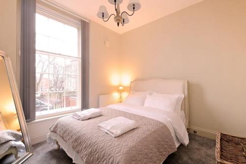 a bedroom with a bed with two towels on it at The Bessemer Suite in Sheffield