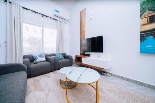 a living room with a couch and a tv at Rio Minho Oasis in Dambani