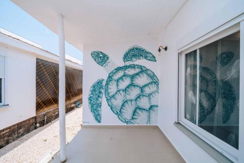 a mural of a turtle on the side of a building at Rio Minho Oasis in Dambani