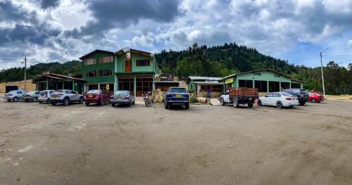 a group of cars parked in a parking lot at Hotel Monteverde Sutatausa in Sutatausa