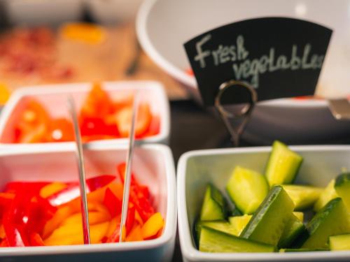 three plastic containers filled with different types of vegetables at EA Hotel Rokoko in Prague