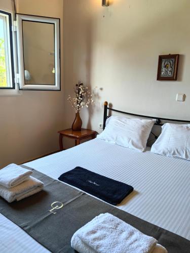 a bedroom with a bed with towels on it at Emis House Krioneri in Kryonéri