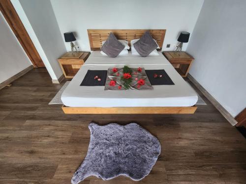a bedroom with two beds with flowers on it at Marquise & Infinity villas in Glacis