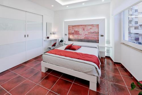 a bedroom with a bed with red pillows on it at La Madegra Seasuite in Salerno