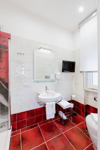 a bathroom with a sink and a shower and a toilet at La Madegra Seasuite in Salerno