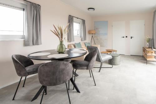 a dining room with a table and chairs at Kompas Camping Nieuwpoort in Nieuwpoort