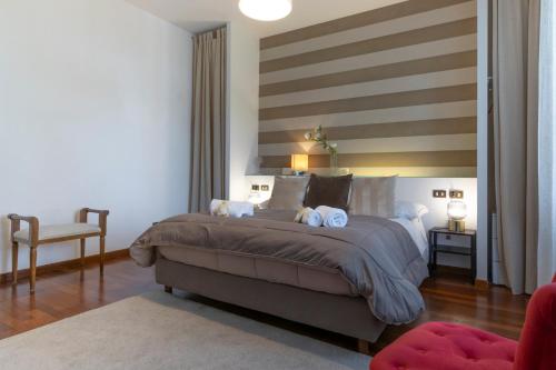 a bedroom with a large bed with two teddy bears on it at Villa Lia - Apartment in Villa with private garden and Pool in Florence