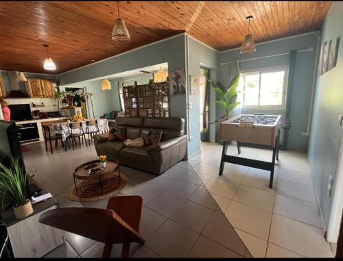 a living room with a couch and a table at Kaz à Naja in Saint-Louis