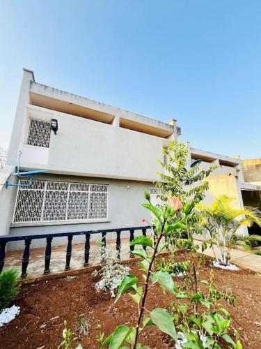 a building with a fence in front of it at Karibu Bomani Villa, Apt in Msaranga