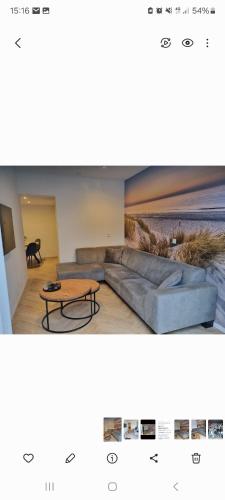 a living room with a couch and a table at Calm Down Near The Sea in Vlissingen