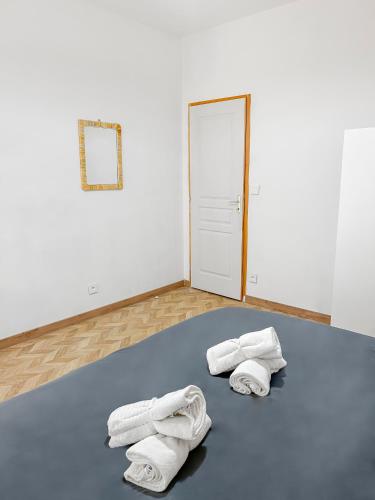 - une chambre avec des serviettes blanches sur un sol bleu dans l'établissement Maison lumineuse avec verrière & grand écran, à Saint-Leu-dʼEsserent