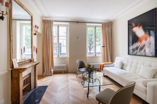 un salon avec un canapé blanc et une table dans l'établissement Elegant and tranquil 1 bed Parasian gem, à Paris