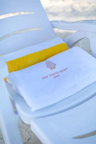 a pile of white towels sitting on a chair at White Harp Beach in Hulhumale