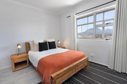 a bedroom with a large bed and a large window at Searenity Sands by Host Agents in Strand