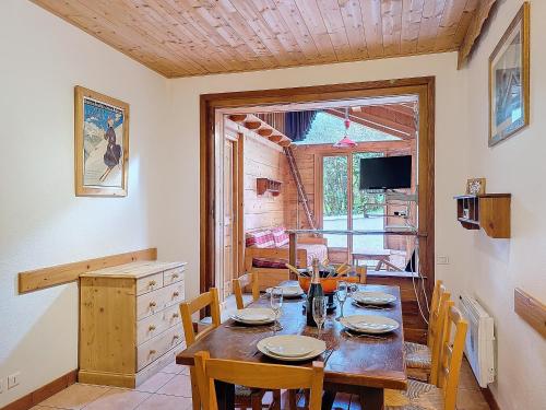une salle à manger avec une table et des chaises en bois dans l'établissement Appartement à 600m des remontées mécaniques, centre Morzine, chalet les Joux, à Morzine