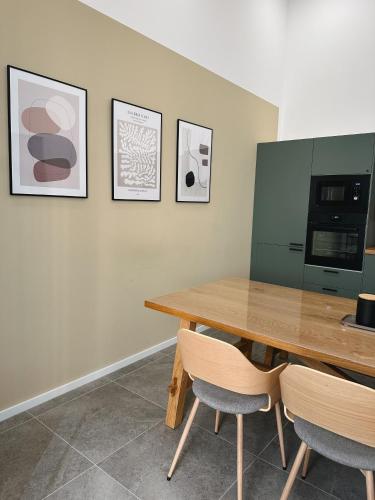a dining room with a wooden table and two chairs at Hotel Traube Rheinhessen in Worms