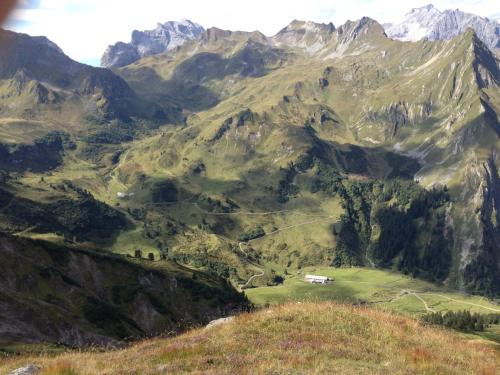 a mountain view of a valley with a house in the middle at Hotel Hirschen in Silbertal
