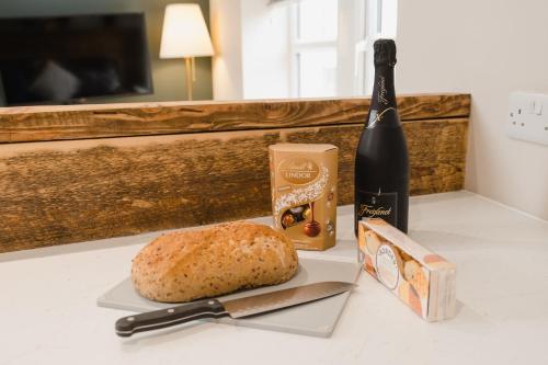 a loaf of bread and a bottle of wine on a counter at Swan House in Huddersfield