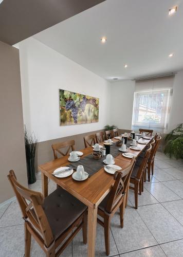 a large dining room with a long wooden table and chairs at Hotel Traube Rheinhessen in Worms