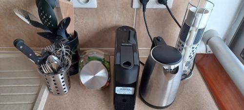 a counter with various kitchen appliances on it at NANA - Grand Appartement - C32- Cuisine équipée- CLIM-WIFI-Terrasse in Cayenne