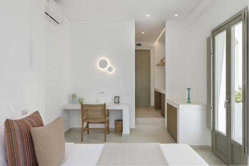 a kitchen and living room with a table and chairs at ANEMOLETHE in Kimolos