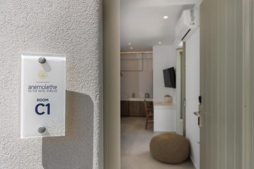 a white lightswitch on a wall in a room at ANEMOLETHE in Kimolos