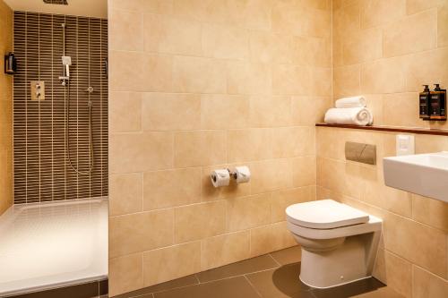 a bathroom with a toilet and a sink and a shower at Sunday London Staines-upon-Thames Heathrow T5 in Staines