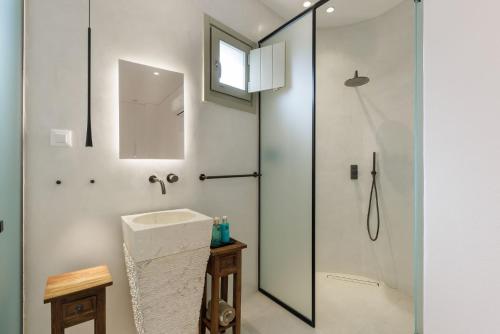 a bathroom with a shower and a sink at ANEMOLETHE in Kimolos