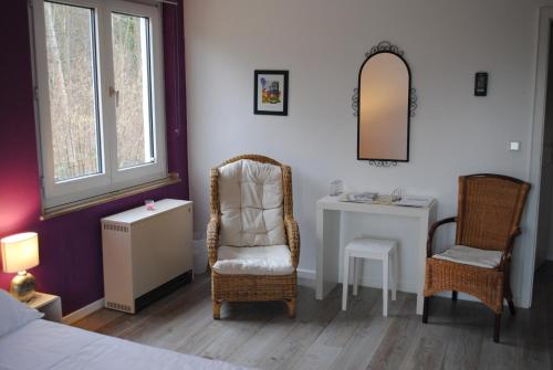 a bedroom with a bed and a chair and a desk at Villa Donar in Cologne