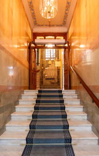 a staircase leading up to a building with a chandelier at Best Western Hotel Bentleys in Stockholm