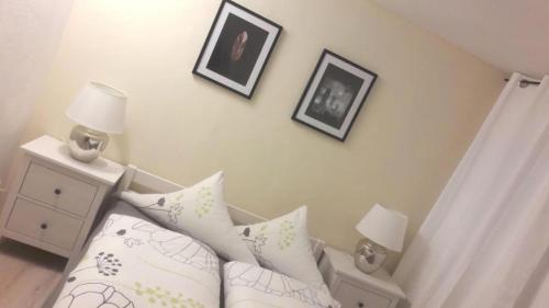 a bedroom with a bed and two pictures on the wall at Wohnung mit Terasse im Schwarzwald in Seebach