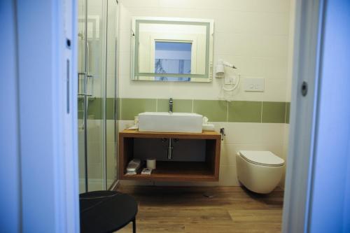 a bathroom with a sink and a toilet and a mirror at B&B del Parco in Cosenza