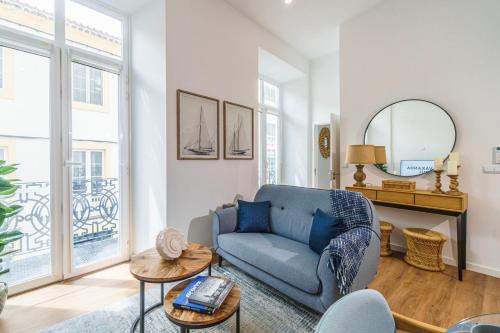 a living room with a blue couch and a table at Varanda Azul - First Mate Loft (City Centre) in Ponta Delgada