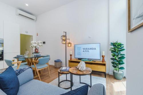 a living room with a couch and a table at Varanda Azul - First Mate Loft (City Centre) in Ponta Delgada