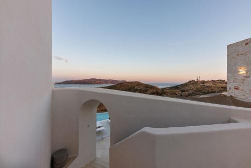 a white house with a view of the ocean at ANEMOLETHE in Kimolos