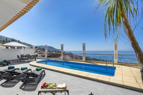 a swimming pool with a view of the ocean at Villa Atlantic Sunset by Villa Plus in Funchal