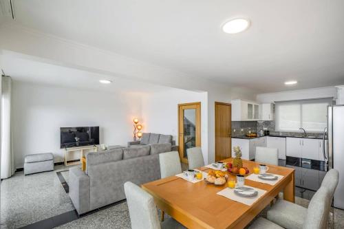 a living room with a table and a couch at Villa Atlantic Sunset by Villa Plus in Funchal