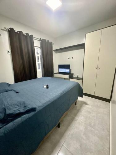 a bedroom with a bed and a television in it at Apto completo a alguns metros do Shopping Macapá in Macapá