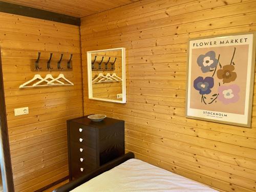 a bedroom with wooden walls and a bed and a mirror at Chalet 22 Bernau in Bernau im Schwarzwald
