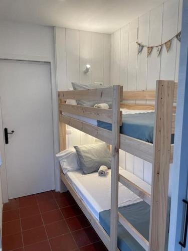 a couple of bunk beds in a room at Casa pintora Neus in Cadaqués