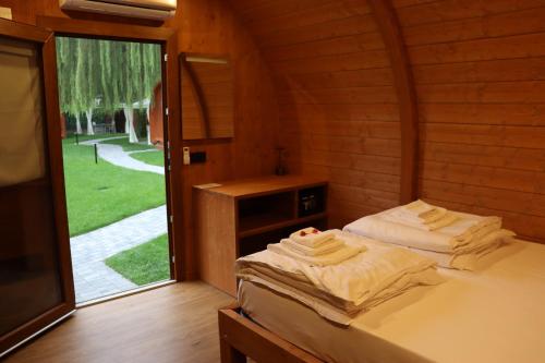 a room with two beds in a wooden cabin at Vicolungo Glamour Lodge & SPA - Free SPA Hot Tub e Sauna in Vicolungo