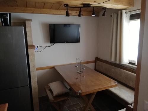 a room with a table and a tv on the wall at Appartamenti Cardinali in Assisi