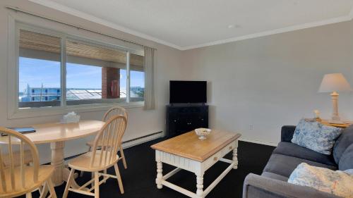 a living room with a table and a couch at Montauk Oceanside Suites in Montauk