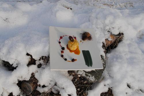 a plate of food sitting on the snow at Monaco Sport Hotel in Santo Stefano di Cadore