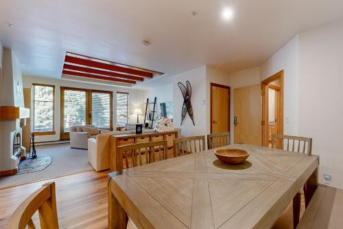 a dining room and living room with a wooden table at Stay in Solitude - Creekside 102 in Solitude