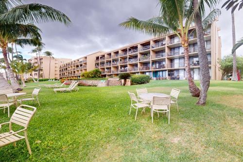 a table and chairs in front of a building at Maalaea Banyans 105 in Wailuku