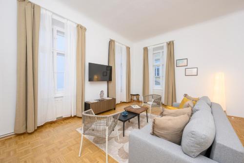 a living room with a couch and a tv at Spacious apartment in Graz for 6 people in Graz